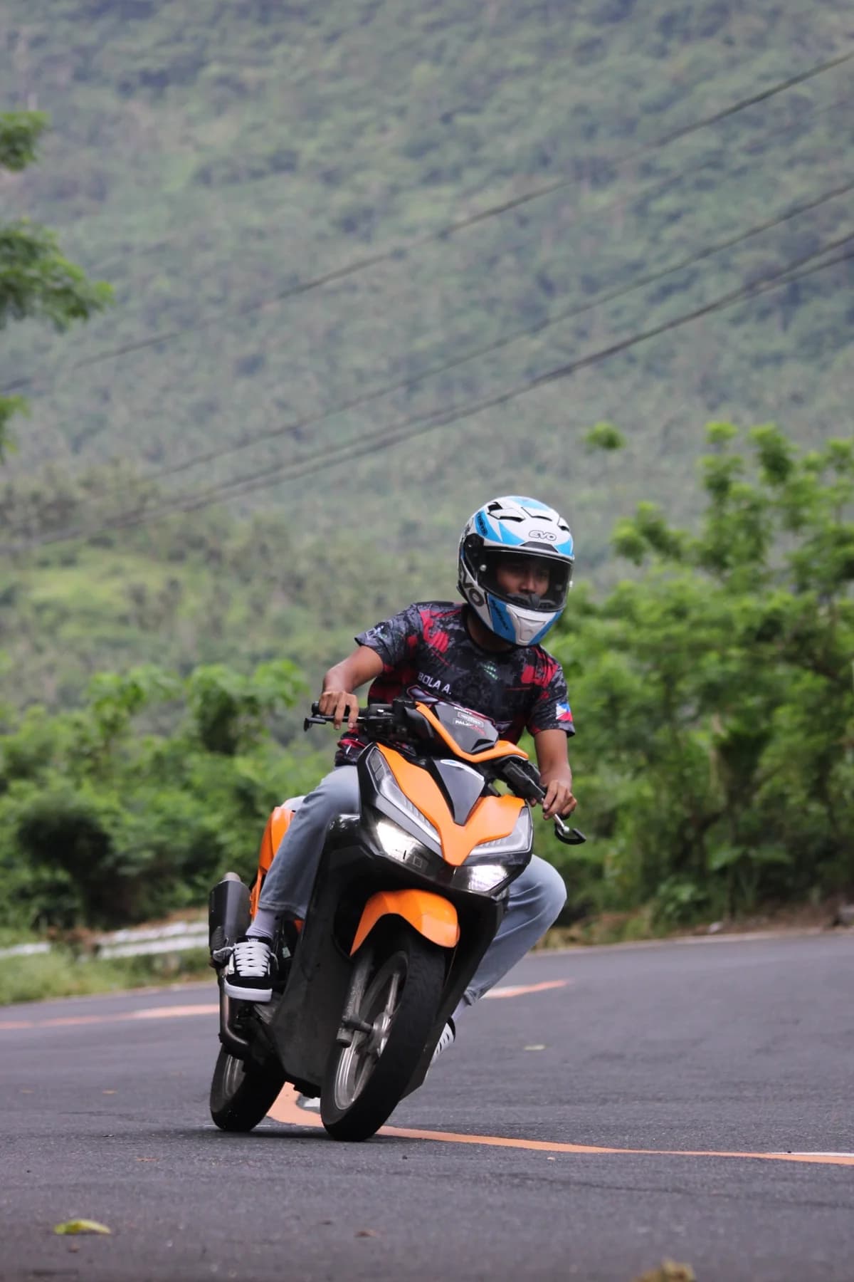 Moto laranja em estrada rural de mata